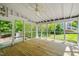 Bright screened porch with wood flooring and views of the backyard at 4500 Lancashire Dr, Raleigh, NC 27613