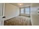 Cozy bedroom with neutral walls, plush carpet, and a window with privacy blinds at 4716 Princess Lita Way, Raleigh, NC 27610