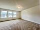 Bright bedroom with neutral walls, plush carpet and large windows offering neighborhood views at 4716 Princess Lita Way, Raleigh, NC 27610