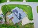 Detailed aerial view features the roof with solar panels, manicured lawn, and tree-lined streets at 4953 Mashpee Ln, Apex, NC 27539