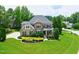 Beautiful aerial view of home with mature trees, manicured lawn, and circular driveway at 4953 Mashpee Ln, Apex, NC 27539