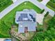 Bird's-eye aerial view shows solar panels, landscaping, driveway, and surrounding neighborhood at 4953 Mashpee Ln, Apex, NC 27539