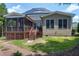 Back of the home featuring a screened in porch, patio, with solar panels on the roof at 4953 Mashpee Ln, Apex, NC 27539