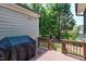 Back porch with covered grill and view of wooded backyard at 4953 Mashpee Ln, Apex, NC 27539