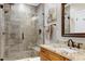 Modern bathroom featuring glass-enclosed shower, tiled walls, and granite vanity at 4953 Mashpee Ln, Apex, NC 27539
