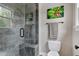 Modern bathroom featuring glass-enclosed shower, tiled walls, and granite vanity at 4953 Mashpee Ln, Apex, NC 27539