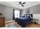 Comfortable bedroom with a ceiling fan, stylish decor, and natural light from the window at 4953 Mashpee Ln, Apex, NC 27539