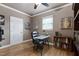 Comfortable bedroom with hardwood floors, a ceiling fan, and a glass desk in a home's interior at 4953 Mashpee Ln, Apex, NC 27539