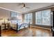 Comfortable bedroom features hardwood floors, ceiling fan, and ample natural light at 4953 Mashpee Ln, Apex, NC 27539