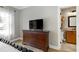 Bedroom featuring hardwood floors, dresser, and view into ensuite bathroom at 4953 Mashpee Ln, Apex, NC 27539
