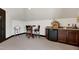 Bonus room features a mini-bar area with granite countertops, a table with seating, and neutral walls at 4953 Mashpee Ln, Apex, NC 27539