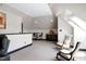 Spacious bonus room with a wet bar, seating, and neutral colors for a relaxing, multi-functional space at 4953 Mashpee Ln, Apex, NC 27539