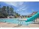 Community pool with multiple swimming lanes, slide, and recreational area on a sunny day at 4953 Mashpee Ln, Apex, NC 27539