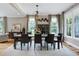 Elegant dining room featuring modern chandelier, large windows, and stylish decor at 4953 Mashpee Ln, Apex, NC 27539
