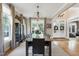 Spacious dining room with modern lighting, large windows, and seating for eight at 4953 Mashpee Ln, Apex, NC 27539