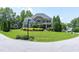 Charming home with manicured lawn, colorful flowerbeds, and traditional architectural details at 4953 Mashpee Ln, Apex, NC 27539