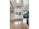 Bright and inviting foyer with hardwood floors, double doors, and staircase access at 4953 Mashpee Ln, Apex, NC 27539