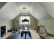 Attic home gym with an array of workout equipment and a window offering natural light at 4953 Mashpee Ln, Apex, NC 27539