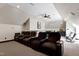 Spacious home theater with tiered seating, a ceiling fan, and a nearby snack and beverage area at 4953 Mashpee Ln, Apex, NC 27539