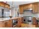 Modern kitchen with stainless steel range, granite countertops, and ample storage at 4953 Mashpee Ln, Apex, NC 27539