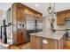 Kitchen island with granite countertops and built-in stainless steel refrigerator at 4953 Mashpee Ln, Apex, NC 27539