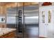 Gourmet kitchen features stainless steel appliances, wine cooler, custom cabinets, and pantry at 4953 Mashpee Ln, Apex, NC 27539