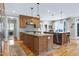 Spacious kitchen with hardwood floors, large island, and modern stainless steel appliances at 4953 Mashpee Ln, Apex, NC 27539