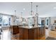 Bright, spacious kitchen with double island, granite countertops, stainless sink, and hardwood floors at 4953 Mashpee Ln, Apex, NC 27539