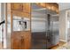 Close-up of stainless steel refrigerator and microwave with granite countertop island at 4953 Mashpee Ln, Apex, NC 27539