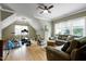 Bright living room featuring ample natural light, a ceiling fan, and comfortable seating area at 4953 Mashpee Ln, Apex, NC 27539
