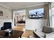 Open-concept living room featuring modern decor, wainscoting, and mounted television at 4953 Mashpee Ln, Apex, NC 27539