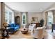 Sunlit living room showcasing a blue sofa, hardwood floors, and ample natural light at 4953 Mashpee Ln, Apex, NC 27539