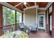 Covered porch with fan, comfortable seating, and railing, perfect for outdoor relaxation at 4953 Mashpee Ln, Apex, NC 27539