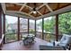 Relaxing screened porch with ceiling fan, outdoor furniture, and wooded backyard views at 4953 Mashpee Ln, Apex, NC 27539
