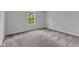 A cozy bedroom features a window offering natural light and neutral-toned carpet at 501 Benton Dr, Oxford, NC 27565