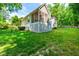 A side view of the backyard and screened porch with outdoor seating and black metal fence at 509 Fish Pond Ct, Rolesville, NC 27571