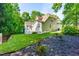 Landscaped backyard featuring green lawn, mulch beds, and partial exterior view of the home at 509 Fish Pond Ct, Rolesville, NC 27571
