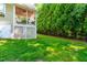The backyard has green grass and a screened porch, complete with a ceiling fan for comfort at 509 Fish Pond Ct, Rolesville, NC 27571