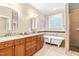 Well-lit bathroom with granite vanity, clawfoot tub, and walk-in shower at 509 Fish Pond Ct, Rolesville, NC 27571