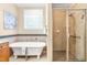 Elegant bathroom with clawfoot tub and walk-in shower at 509 Fish Pond Ct, Rolesville, NC 27571