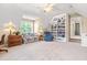 Spacious bonus room with a built-in bookshelf, ceiling fan, and comfortable seating area at 509 Fish Pond Ct, Rolesville, NC 27571