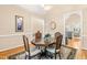Intimate dining area featuring a wooden table, four chairs, and elegant decor at 509 Fish Pond Ct, Rolesville, NC 27571