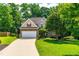 Charming two-story home with stone accents, mature landscaping, and a spacious driveway at 509 Fish Pond Ct, Rolesville, NC 27571
