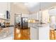 Well-lit kitchen featuring white cabinets, stainless steel appliances, and granite countertops at 509 Fish Pond Ct, Rolesville, NC 27571