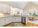 Bright kitchen with white cabinetry, stainless steel appliances, and a seamless design to the dining area at 509 Fish Pond Ct, Rolesville, NC 27571