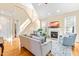 Comfortable living room with fireplace, hardwood floors, and staircase at 509 Fish Pond Ct, Rolesville, NC 27571