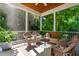 Inviting screened porch with comfortable wicker furniture, perfect for relaxing outdoors at 509 Fish Pond Ct, Rolesville, NC 27571