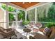 Relaxing screened porch with wicker seating, ceiling fan, and scenic outdoor views at 509 Fish Pond Ct, Rolesville, NC 27571