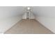 Attic features neutral carpet and a small door on a blank white wall at 525 Allesandra Dr, Clayton, NC 27527