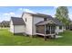 Rear exterior showing a screened-in porch with black railings, and a well-manicured lawn at 525 Allesandra Dr, Clayton, NC 27527